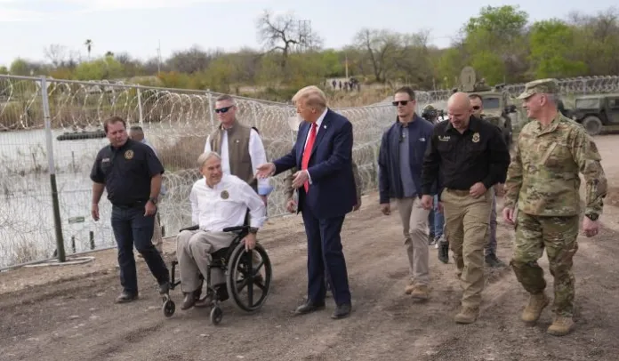 Republican presidential candidate former President Donald Trump talks with Texas Gov. Greg Abbott at Shelby Park during a visit to the U.S.-Mexico border, Thursday, Feb. 29, 2024, in Eagle Pass, Texas. (AP Photo/Eric Gay)