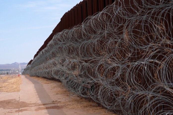 Newly installed concertina wire blankets a portion of the US-Mexico border wall, as part of the Joint Task Force Southern Border, Thursday, April 3, 2025, in Douglas, Ariz. (AP Photo/Ross D. Franklin)