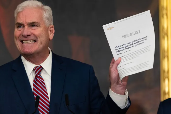 House Majority Whip Tom Emmer (R-MN) holds up a press release.