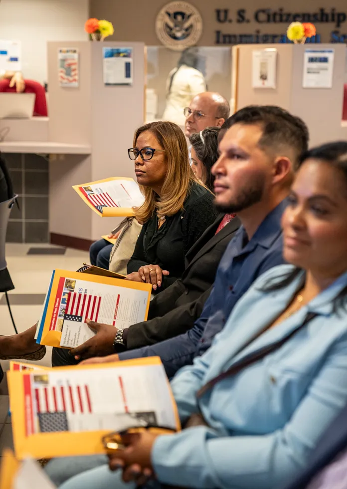 Candidates for U.S. citizenship wait to receive their certificates of naturalization during a formal ceremony June 4, 2025 in the Manhattan borough of New York City. One hundred and twenty applicants from thirty-nine countries received their certificates of citizenship at the ceremony. In fiscal year 2024, the U.S. Citizenship and Immigration Services (USCIS) naturalized approximately 818,500 new U.S. citizens nationwide. (Photo by Robert Nickelsberg/Getty Images)