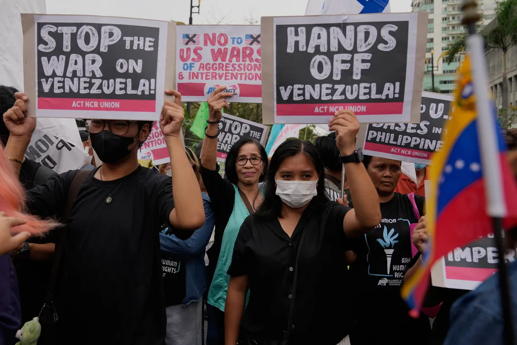 Protesters hold slogans as they denounce the U.S. government and U.S. President Donald Trump after the U.S. captured Venezuelan President Nicolas Maduro during a rally near the U.S. Embassy in Manila, Philippines on Monday, Jan. 5, 2026. (AP Photo/Aaron Favila)