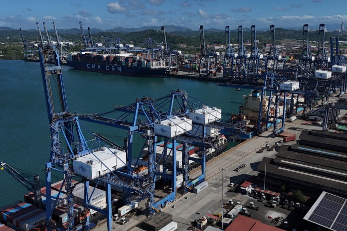 Cranes load a cargo ship at Panama Canal's Port of Balboa, managed by CK Hutchison Holdings, in Panama City, Friday, Jan. 30, 2026.