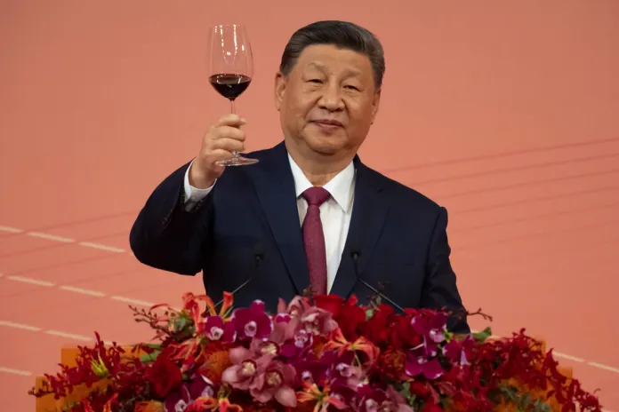 Xi Jinping raises a wine glass at a celebration in Beijing