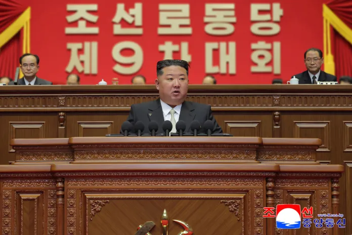 Kim Jong Un delivers a speech from the on-stage podium at the Worker's Party Congress