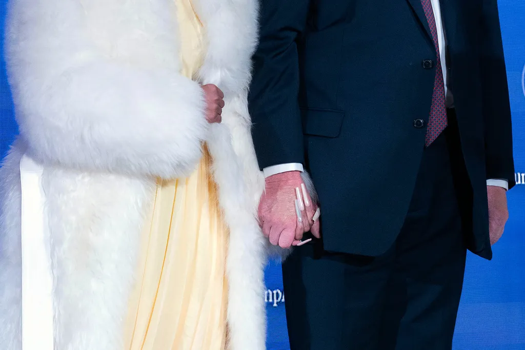 Rapper Nicki Minaj and President Donald Trump hold hands.