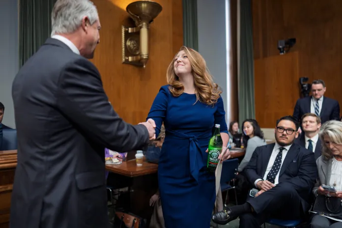 Wellness influencer and entrepreneur Dr. Casey Means is welcomed by Sen. Roger Marshall, R-Kan., left, as she appears before the Senate health committee to seek approval to be U.S. surgeon general, at the Capitol in Washington, Wednesday, Feb. 25, 2026.