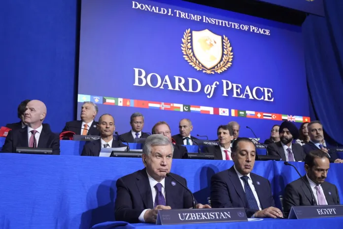 Various world leaders sit at their positions for the Board of Peace meeting