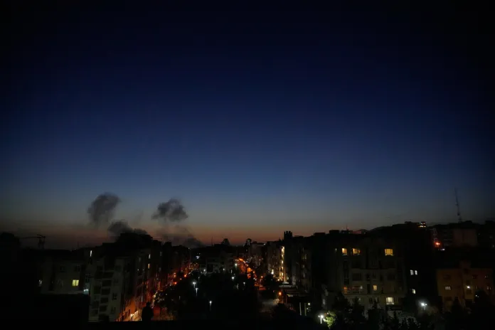 Smoke rises from an airstrike impact site in Iran