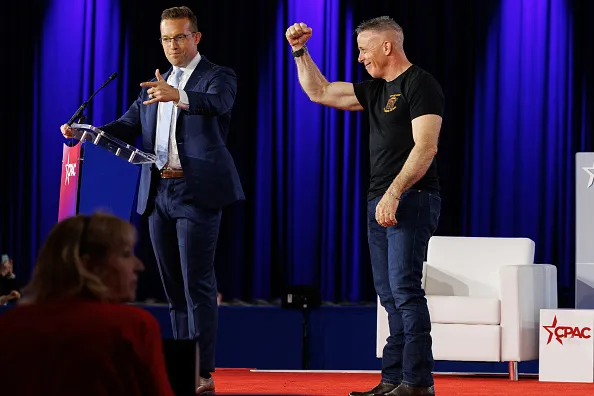 Former Border Patrol Chief Gregory Bovino, right, is introduced during the Conservative Political Action Conference (CPAC) in Grapevine, Texas, US, on Thursday, March 26, 2026. The Conservative Political Action Conference launched in 1974 brings together conservative organizations, elected leaders, and activists. 