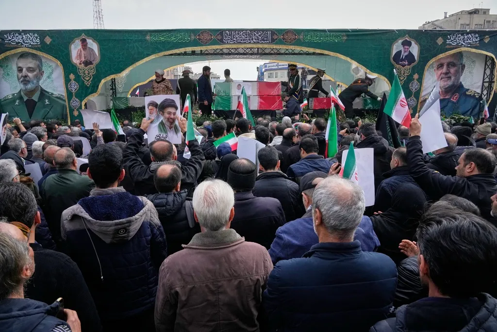 Mourners attend the funeral procession for senior Iranian military officials and some civilians killed during the U.S.-Israel campaign, including Islamic Revolutionary Guard Corps commander Mohammad Pakpour, Defense Minister Aziz Nasirzadeh, Supreme Leader military office chief Mohammad Shirazi, and other officers in Tehran, Iran, Wednesday, March 11, 2026. 