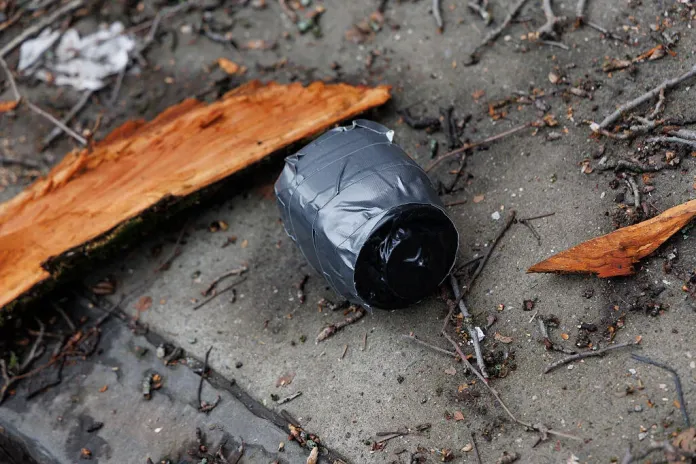 A homemade explosive device is seen on the ground after a left-wing protester throws the device at a demonstration.