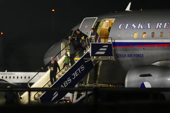 Passengers deplane from an aircraft in Prague