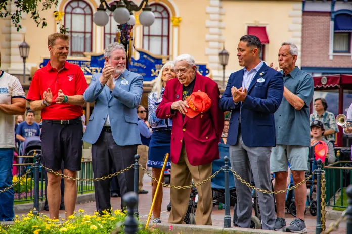 Anaheim, Calif. (March 31, 2026) – Charles Cram is honored during the daily Flag Retreat ceremony at Disneyland Park, where 100-year-old World War II veteran Charles Cram was honored for his military service in front of park guests and his family. Cram served as a U.S. Navy Pharmacist’s Mate Second Class with the 5th Marine Division during the Battle of Iwo Jima—one of the most pivotal battles of the Pacific