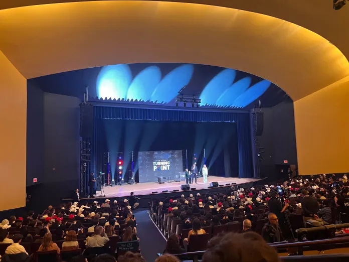 Crowds at the kickoff to Turning Point USA's spring college tour watch Jack Posobiec, his wife, Tanya, and their children at George Washington University on April 2, 2026. (Washington Examiner/Britta Miller)