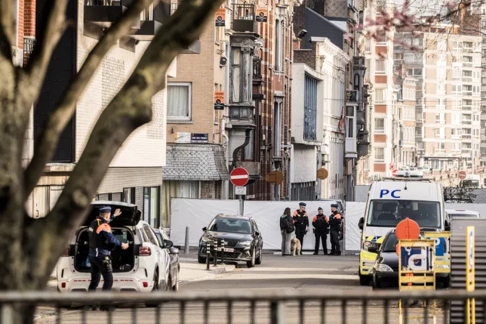 Police stand near barricades as they secure an area after a blast took place near a synagogue, in Liege, Belgium, Monday, March 9, 2026.