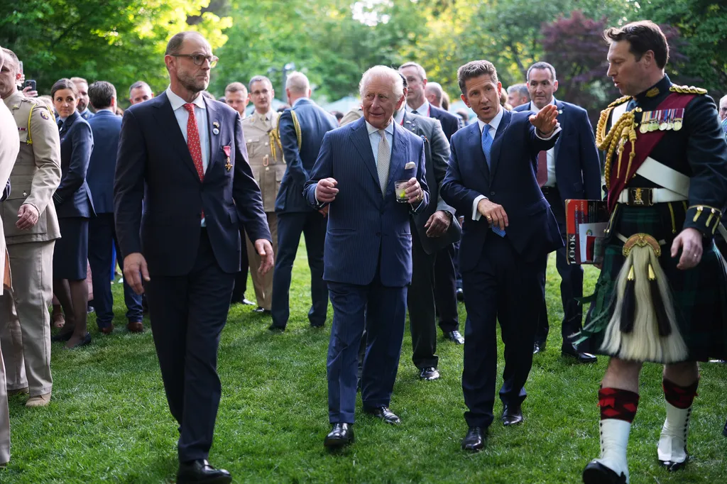 Britain's King Charles III and British Ambassador to the U.S. Christian Turner, right, attend a garden party at the British Embassy