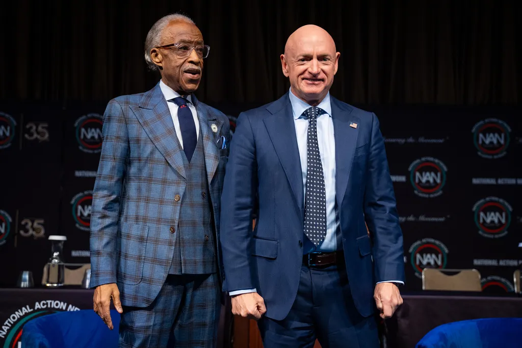 Sen. Mark Kelly (D-AZ) poses with the Rev. Al Sharpton at the National Action Network Convention.