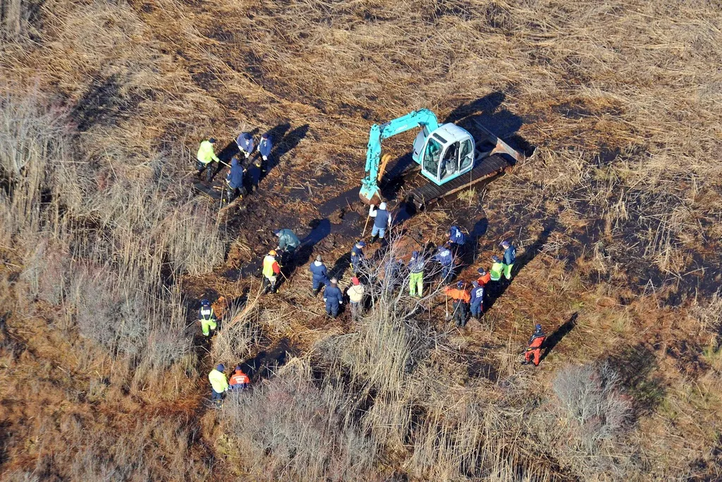 In this Dec. 8, 2011 photo, investigators use a backhoe to dig while searching for Shannan Gilbert's body in different sectors of a marsh area just east of Oak Beach, N.Y. A Long Island architect has been charged, Friday, July 14, 2023, with murder in the deaths of three of the 11 victims in a long-unsolved string of killings known as the Gilgo Beach murders. (AP Photo/Kevin P. Coughlin, File)