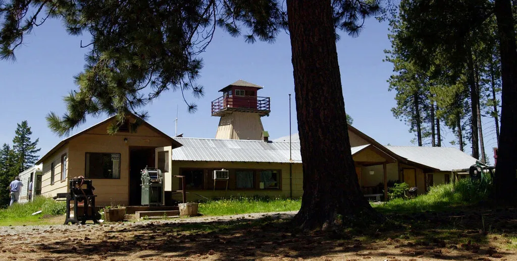 In this May 22, 2001, file photo, the former headquarters of the neo Nazi Aryan Nations stands deserted in a wooded lot near Coeur d'Alene, Idaho. The house where Aryan Nations founder Richard Butler lived has been demolished. So has the church where he preached his racist religion. (AP Photo/Elaine Thompson)