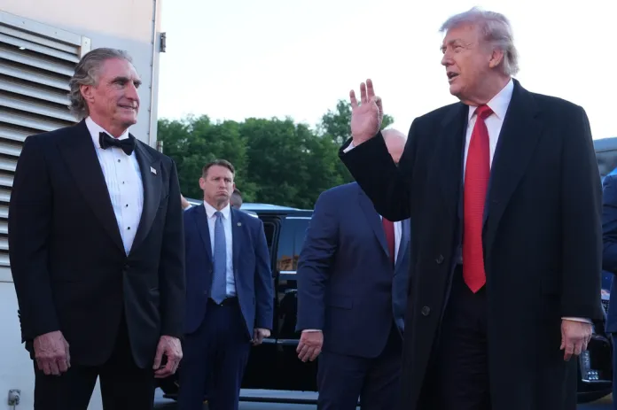 President Donald Trump gestures to Interior Secretary Doug Burgum as he speaks during visit to the Lincoln Memorial Reflecting Pool to see the new blue protective coating being applied as part of a renovation project, Thursday, May 7, 2026, in Washington. (AP Photo/Mark Schiefelbein)