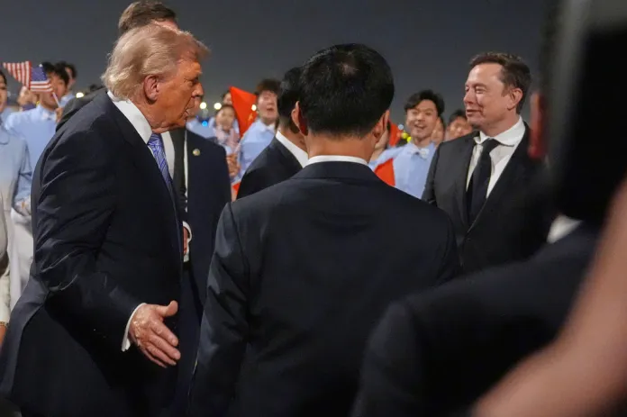 President Donald Trump talks with Elon Musk, right, during and arrival ceremony Wednesday, May 13, 2026, at Beijing Capital International Airport in Beijing. (AP Photo/Mark Schiefelbein)
