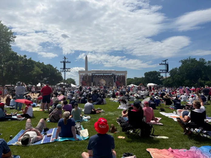 Americans sitting and standing on the National Mall for Rededicate 250.