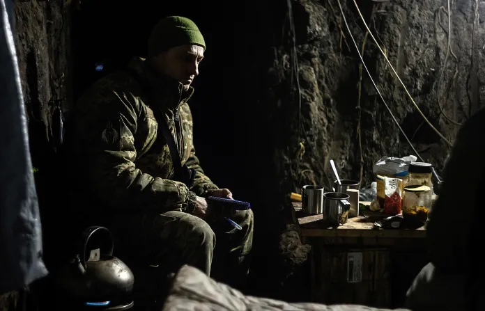 A Ukrainian serviceman sits in a shelter on his position at the front line near Donetsk. (Roman Chop/AP)