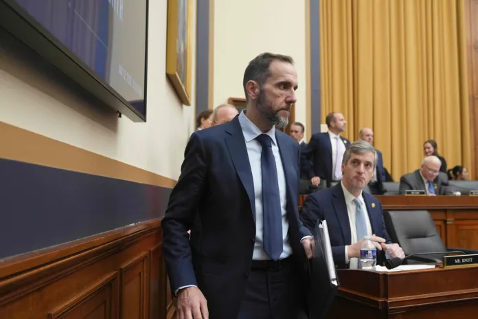 Former Justice Department special counsel Jack Smith, left, walks past Rep. Brad Knott, R-N.C., before he testifies before the House Judiciary Committee about his investigations into President Donald Trump, Thursday, Jan. 22, 2026 at the Capitol in Washington. (AP Photo/Jacquelyn Martin)