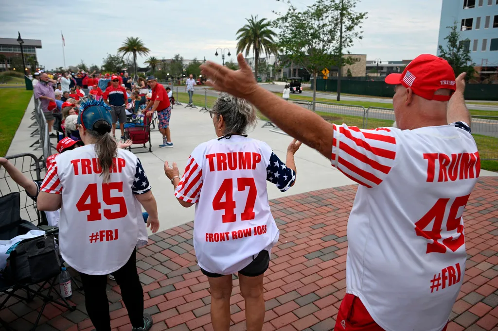 Supporters dance while waiting in line.