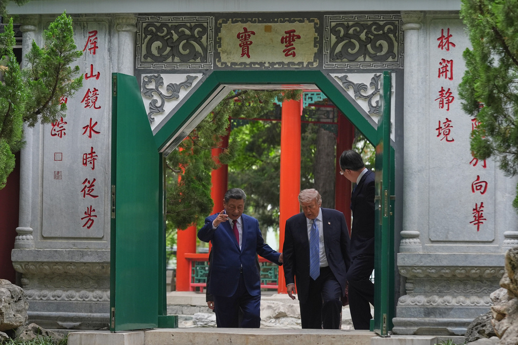 President Donald Trump walks with China's President Xi Jinping at the Zhongnanhai leadership compound, Friday, May 15, 2026, in Beijing. (AP Photo/Mark Schiefelbein, Pool)