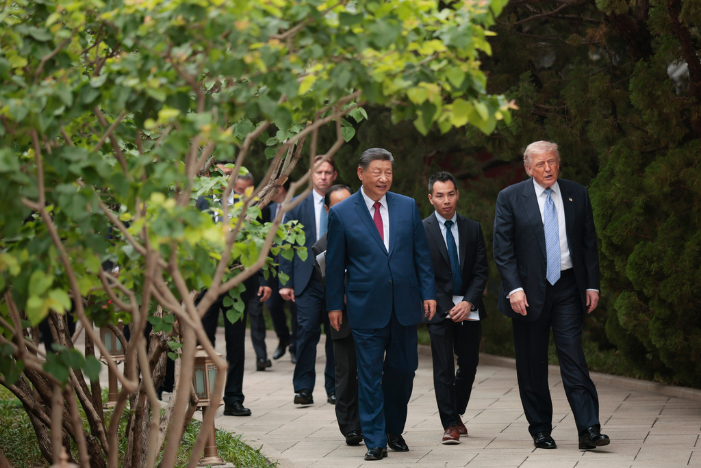 U.S. President Donald Trump, right, walks with Chinese President Xi Jinping while leaving after a visit to the Zhongnanhai Garden in Beijing, Friday, May 15, 2026. (Evan Vucci/Pool Photo via AP)