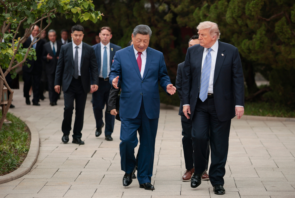 U.S. President Donald Trump, right, walks with Chinese President Xi Jinping while leaving after a visit to the Zhongnanhai Garden in Beijing, Friday, May 15, 2026. (Evan Vucci/Pool Photo via AP)