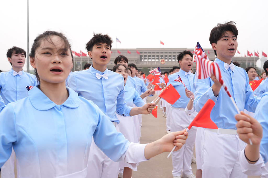 Chinese youth performers perform as President Donald Trump boards Air Force One, Friday, May 15, 2026, at Beijing Capital International Airport in Beijing. (AP Photo/Mark Schiefelbein)