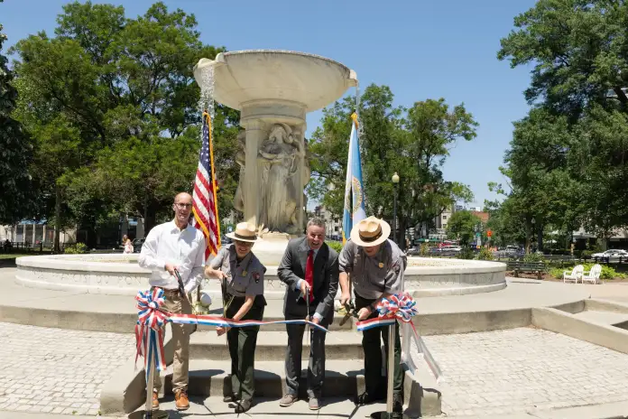 National Park Service officials cut the ribbon in Dupont circle to celebrate the fountain flowing with water once again. (National Park Service)