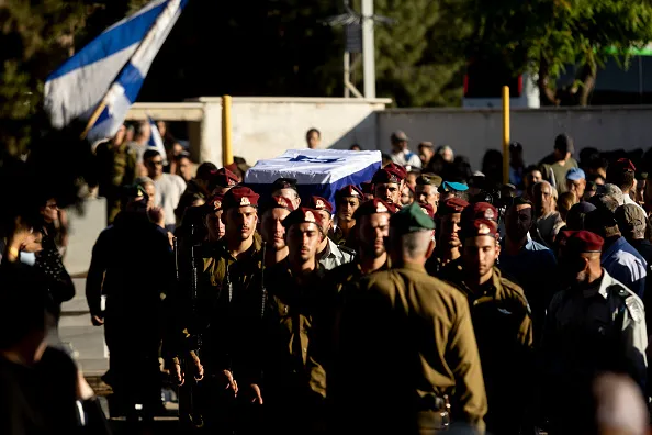 ROSH HAAYIN, ISRAEL - JUNE 1: Israeli soldiers carry a coffin covered with the Israeli flag during a funeral service for Israeli soldier, Staff Sgt. Adam Tzarfati on June 1, 2026 in Rosh HaAyin, Israel. According to the Israeli military, Staff Sgt. Adam Tzarfati was killed overnight by a Hezbollah drone near the southern Lebanon town of Yohmor, near the Beaufort Castle, where Israeli troops were operating. 