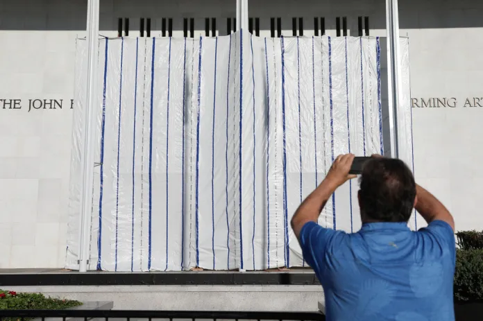 The wall of the John F. Kennedy Center for the Performing Arts is covered in tarp after President Donald Trump's name was removed, in Washington, Saturday, June 13, 2026.