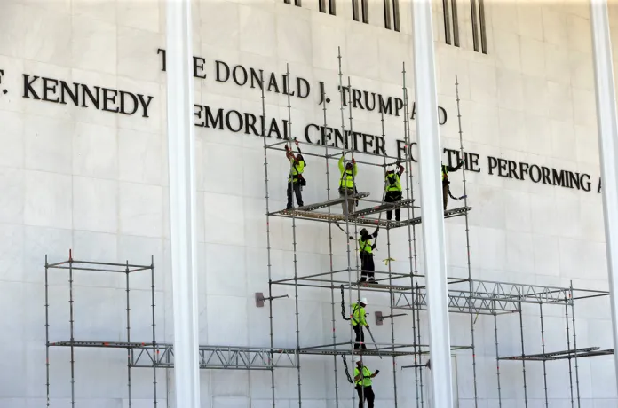 Workers construct scaffolding below the John F. Kennedy Center for the Performing Arts sign Friday, June 12, 2026, in Washington.