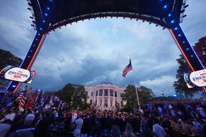 People stand during the National Anthem at UFC Freedom 250 on the South Lawn of the White House, Sunday, June 14, 2026, in Washington.