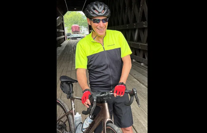 Rahm Emanuel takes a break from a bike ride through New Hampshire, on June 6. (Steven Sloan/AP)