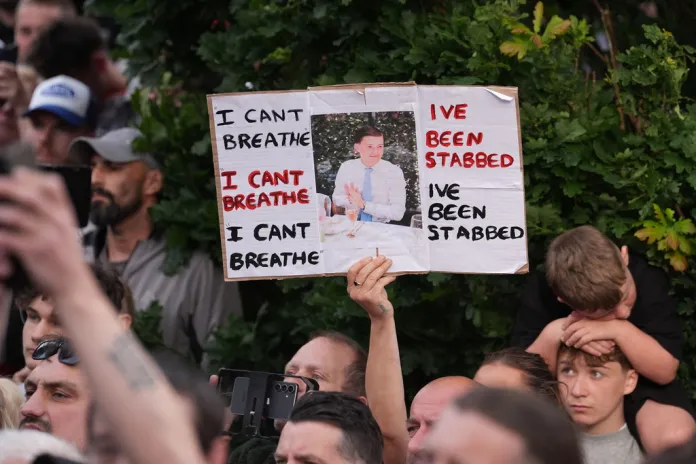 Protester holds up sign showing Nowak