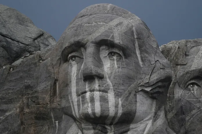Rain runs down a sculpture of George Washington at Mount Rushmore National Memorial, Friday, July 3, 2026, in Keystone, S.D.