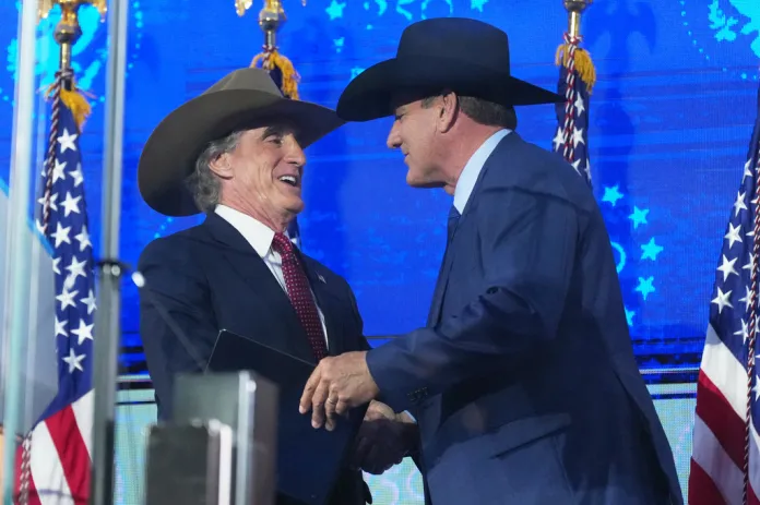 South Dakota Gov. Larry Rhoden, right, greets Interior Secretary Doug Burgum before President Donald Trump speaks at Mount Rushmore National Memorial, Friday, July 3, 2026, near Keystone, S.D.