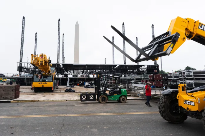 The Washington Monument stands parallel with the metal posts which held the roof of the main stage for the Fourth of July celebrations on the National Mall